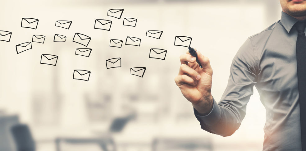 72853748 – sending email concept – businessman drawing envelopes in offiice emails drawn with pen in the air